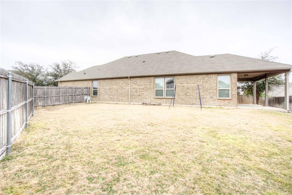 5633 Ridge Lake Drive Fort Worth, TX 76244 - Photo 20 of 23 Back of property featuring a fenced backyard, a patio area, a shingled roof, and brick siding