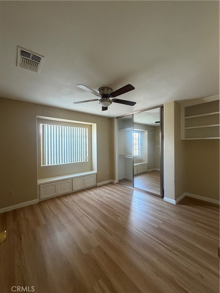 19609 Seneca Road Apple Valley, CA 92307 - Photo 26 of 37 a view of an empty room with wooden floor and a window