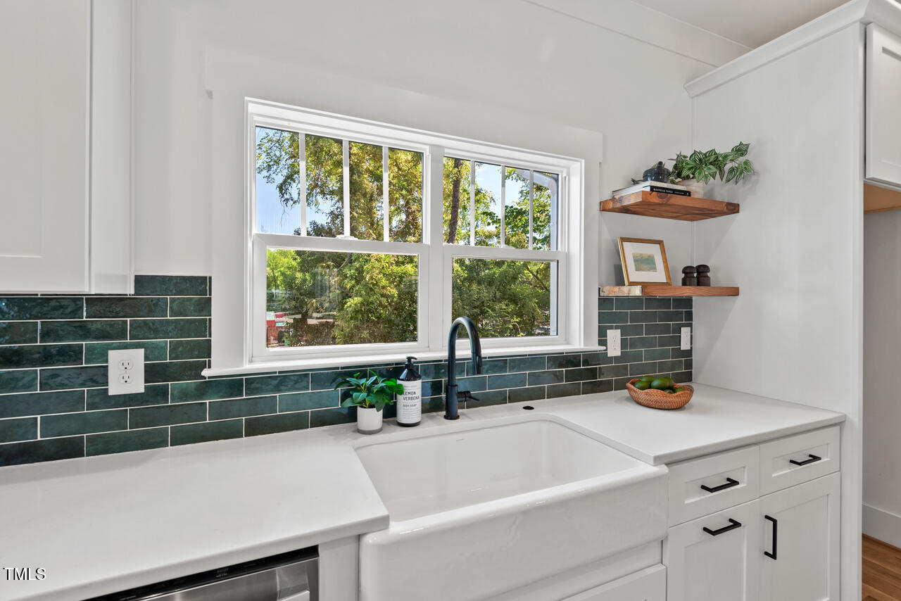 2019 James Street Durham, NC 27707 - Photo 14 of 46 a bathroom with a tub a sink a window and potted plant