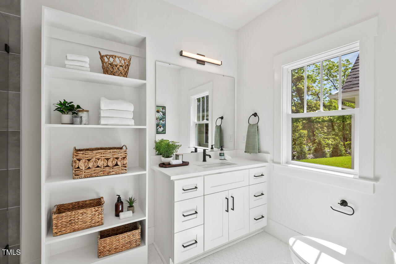 2019 James Street Durham, NC 27707 - Photo 17 of 46 a bathroom with a double vanity sink and a window
