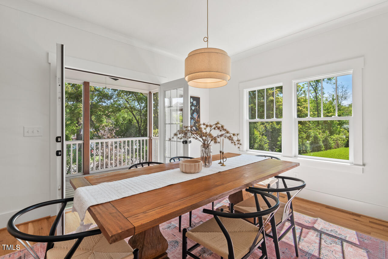 2019 James Street Durham, NC 27707 - Photo 23 of 46 a dining room with furniture a chandelier and wooden floor