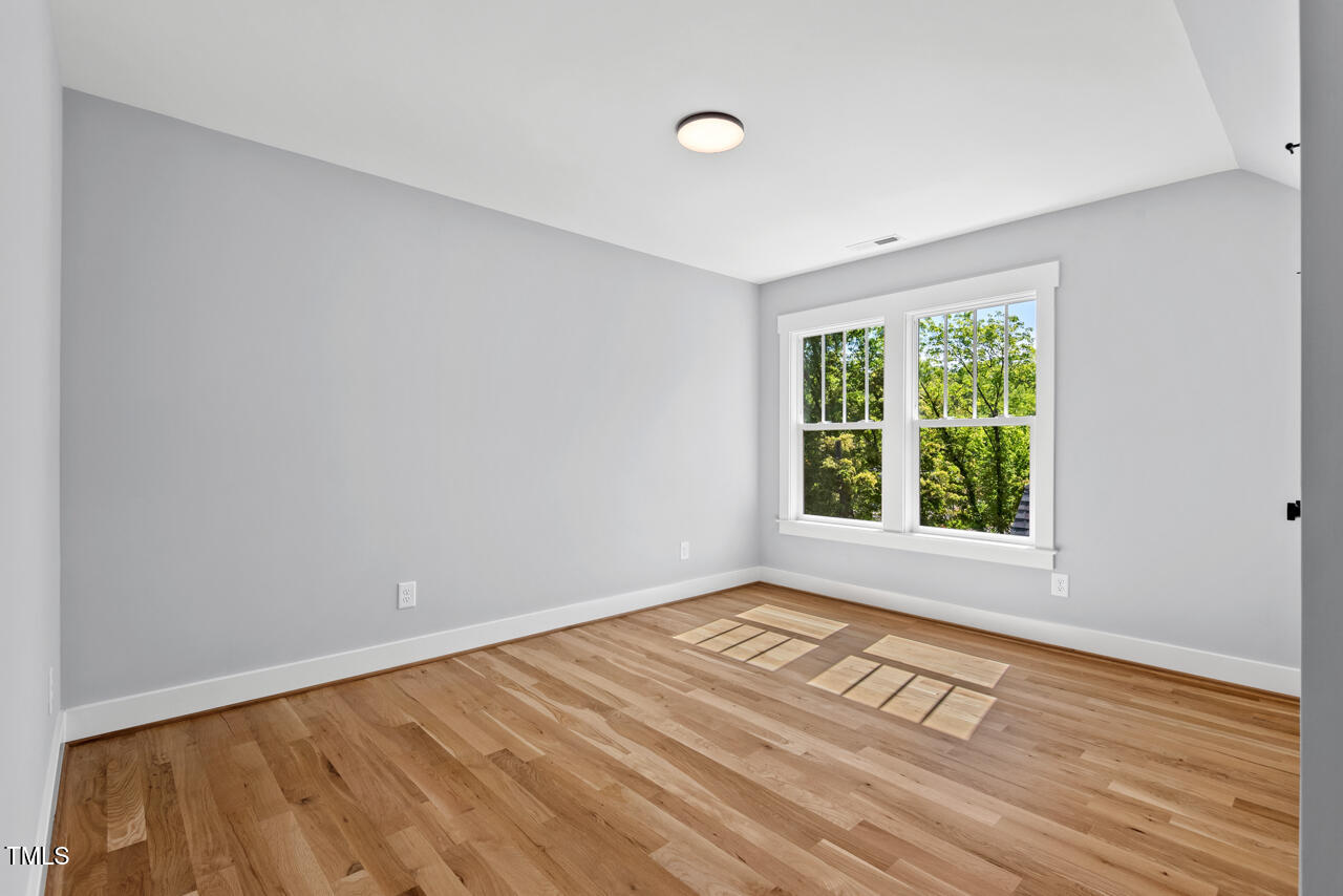 2019 James Street Durham, NC 27707 - Photo 39 of 46 a view of an empty room with wooden floor and a window