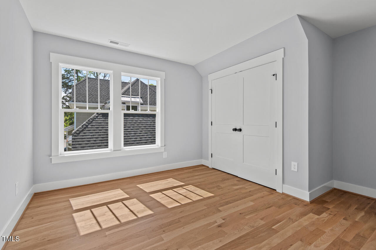 2019 James Street Durham, NC 27707 - Photo 40 of 46 a view of an empty room with wooden floor and a window