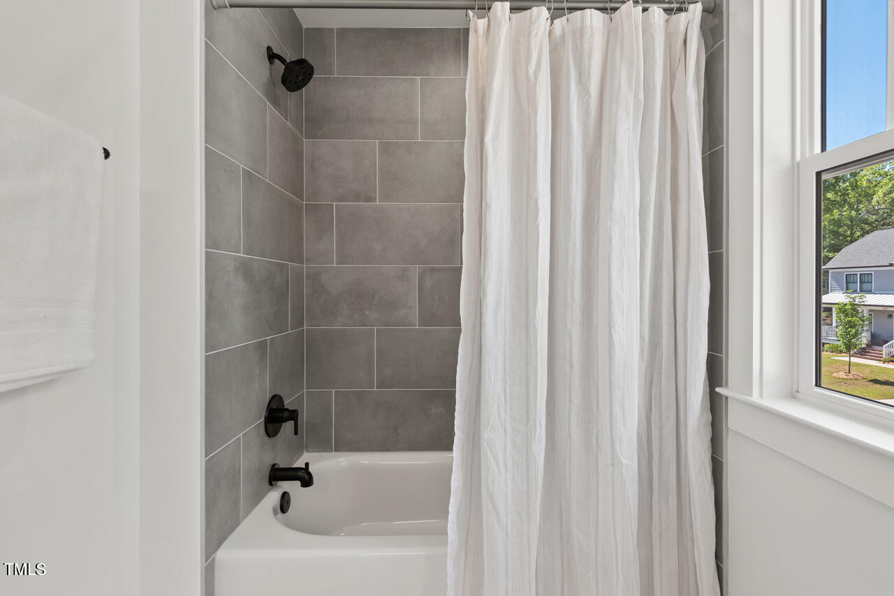 2019 James Street Durham, NC 27707 - Photo 42 of 46 a bathroom with a bathtub and a shower