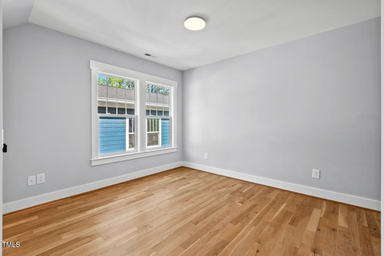2019 James Street Durham, NC 27707 - Photo 43 of 46 a view of an empty room with wooden floor and a window