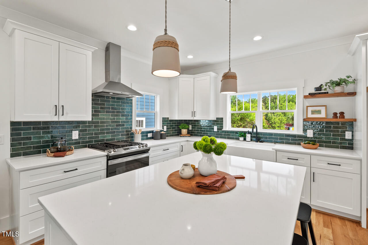 2019 James Street Durham, NC 27707 - Photo 9 of 46 a kitchen with a sink a stove and chairs