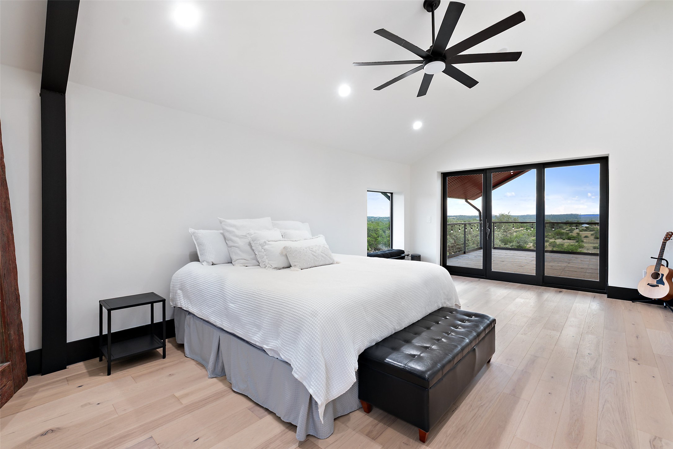 561 Broken Bit Trail Dripping Springs, TX 78620 - Photo 12 of 40 Bedroom with high vaulted ceiling, access to outside, light wood-style floors, recessed lighting, and a ceiling fan