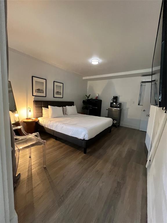 2100 Northeast 33rd Avenue, Unit GS A Fort Lauderdale, FL 33305 - Photo 2 of 12 a bedroom with a bed and wooden floor