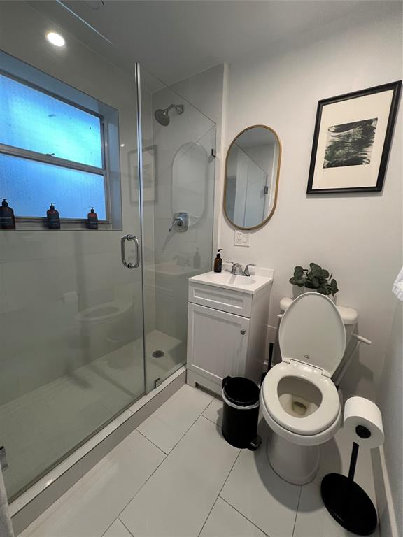 2100 Northeast 33rd Avenue, Unit GS A Fort Lauderdale, FL 33305 - Photo 5 of 12 a bathroom with a toilet a sink and a shower