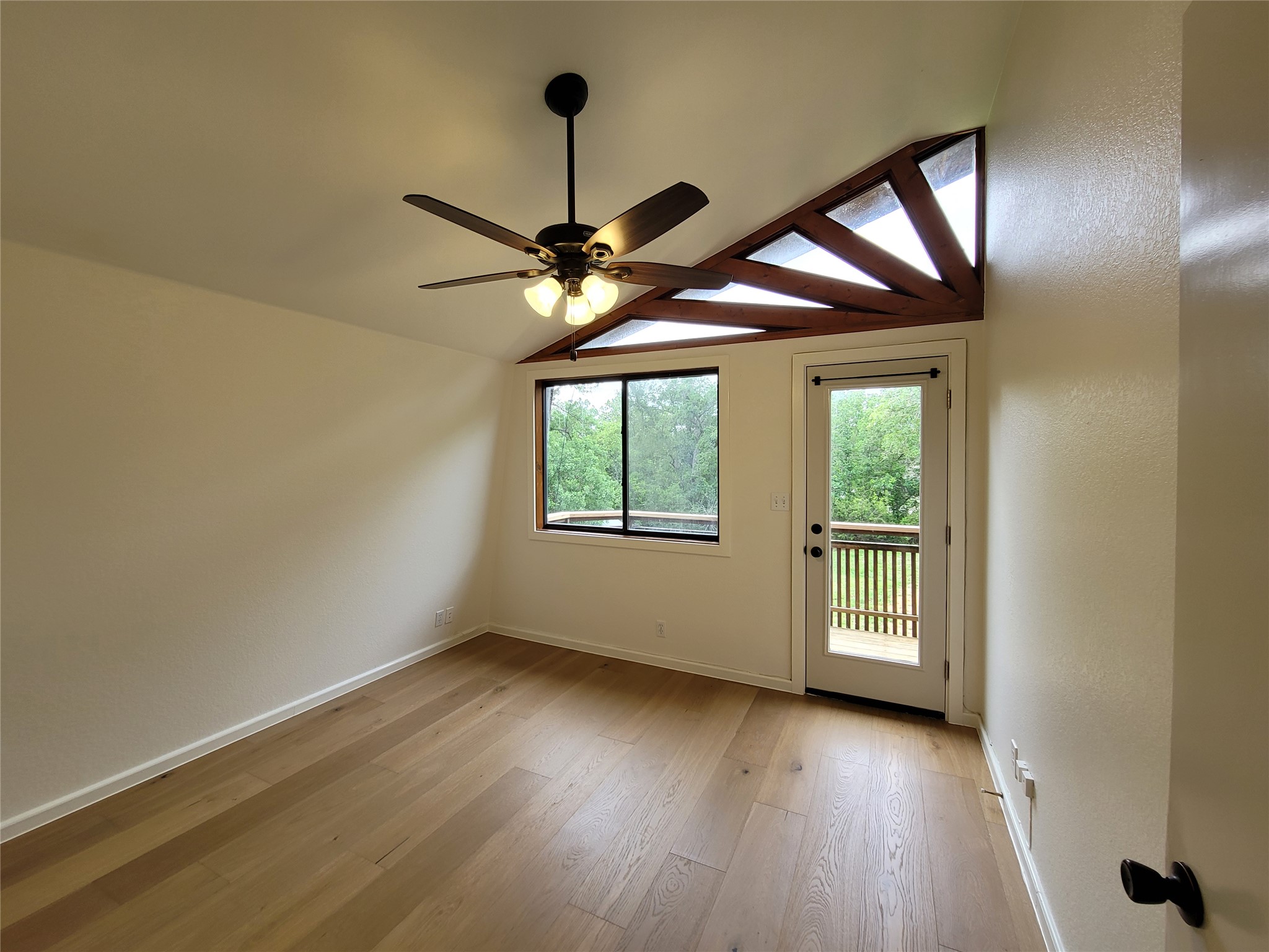 281 Earl Callahan Road, Unit A Cedar Creek, TX 78612 - Photo 27 of 39 wooden floor in an empty room with a window