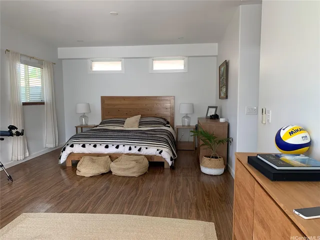a bedroom with furniture and a wooden floor