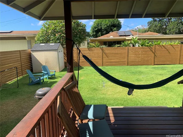 a view of a porch with furniture and yard