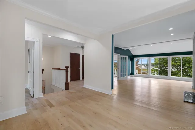 a view of a livingroom with a fireplace and window