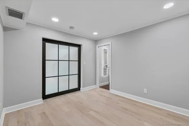 a bathroom with a granite countertop sink a toilet and a mirror
