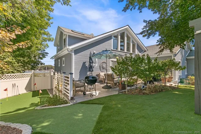 a view of a house with a backyard
