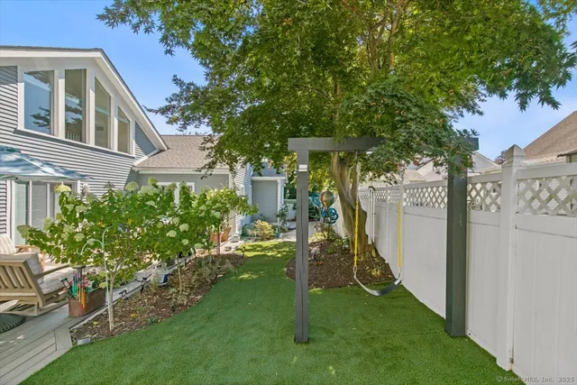 a view of a house with a yard and a garden