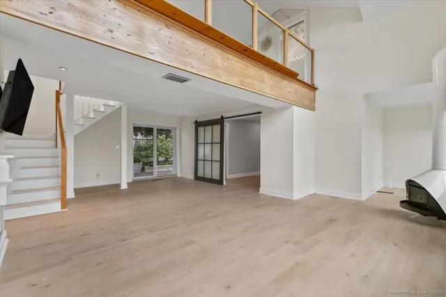 a view of a livingroom with an empty space and a ceiling fan
