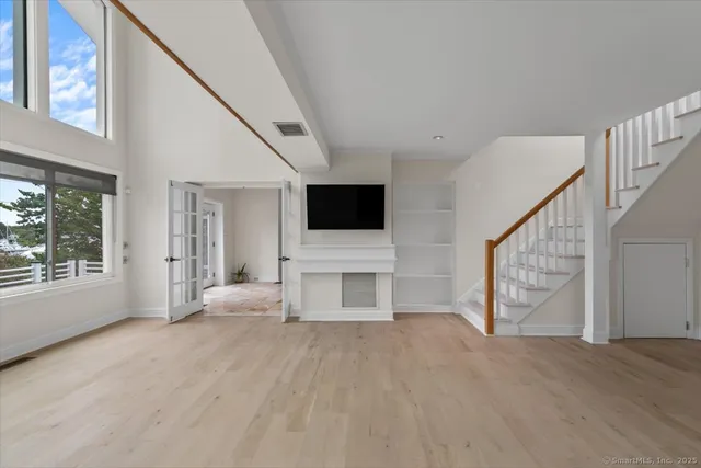 a view of a livingroom with furniture wooden floor and window
