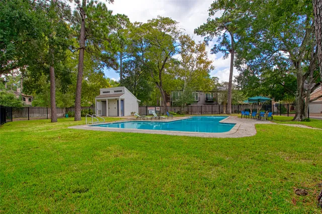 a house view with swimming pool in front of it