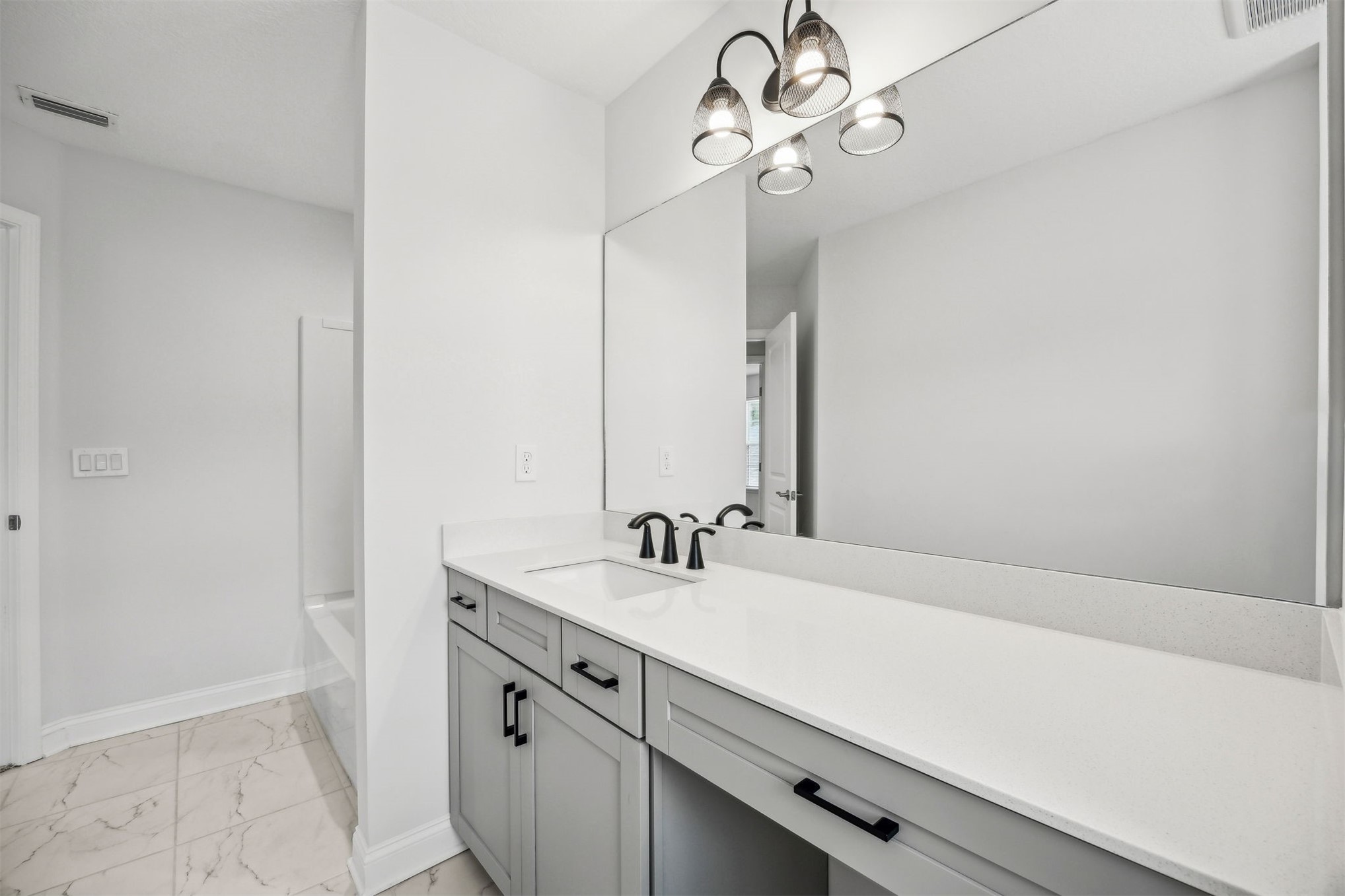230 Wildlight Avenue Yulee, FL 32097 - Photo 28 of 73 a bathroom with a sink a vanity and a mirror