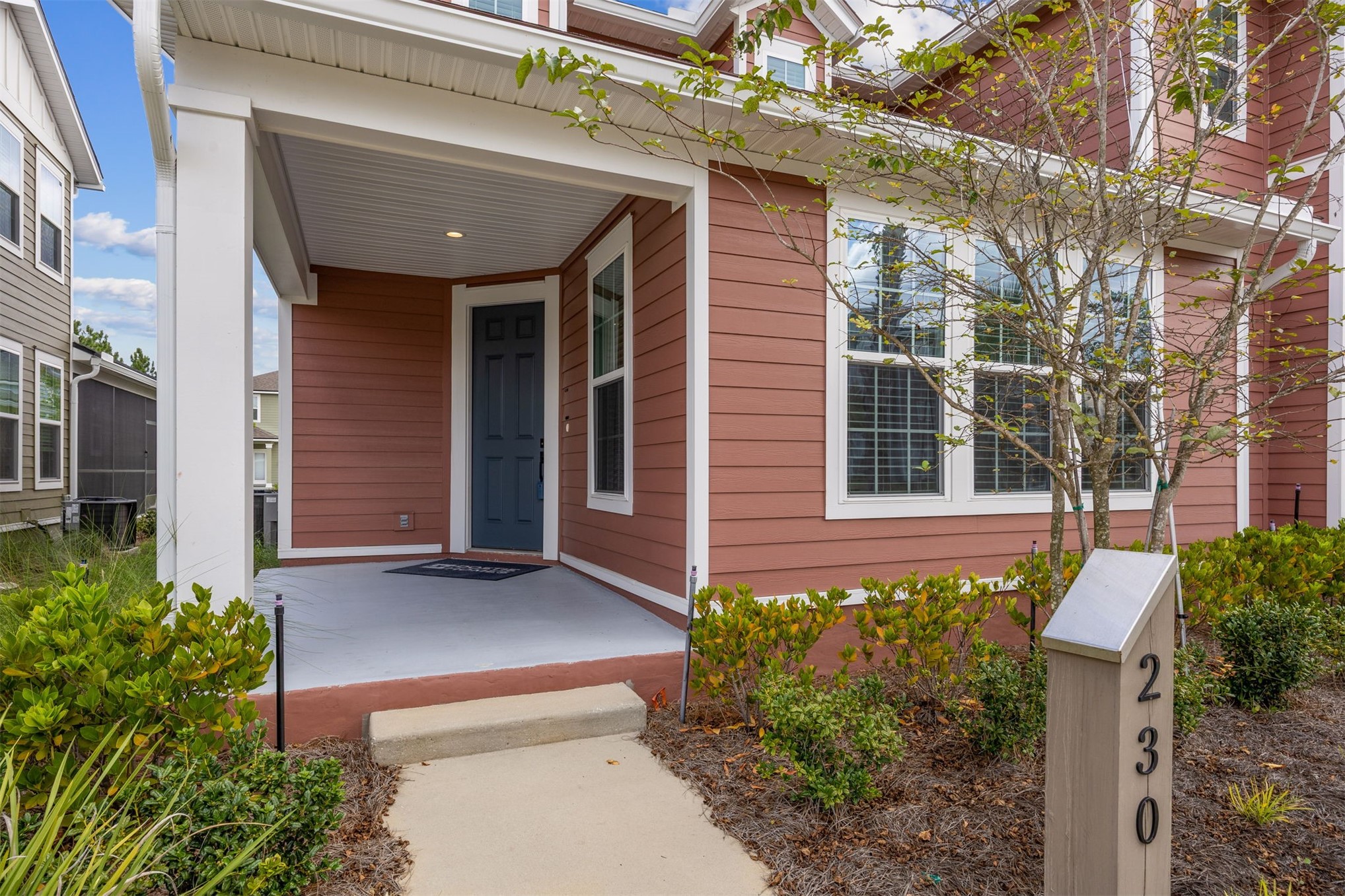 230 Wildlight Avenue Yulee, FL 32097 - Photo 4 of 73 a front view of a house with a garden