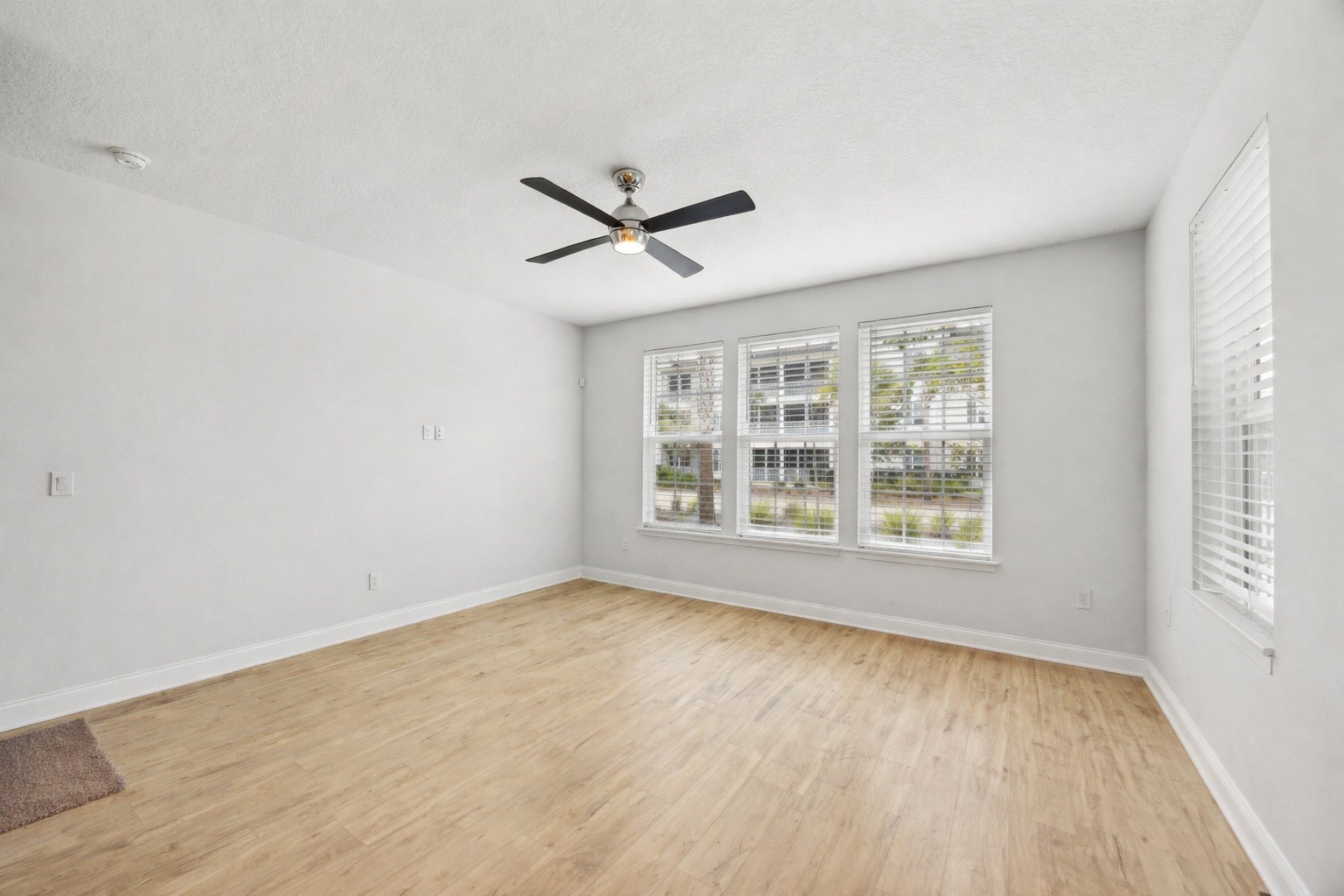 230 Wildlight Avenue Yulee, FL 32097 - Photo 6 of 73 a view of empty room with wooden floor and fan