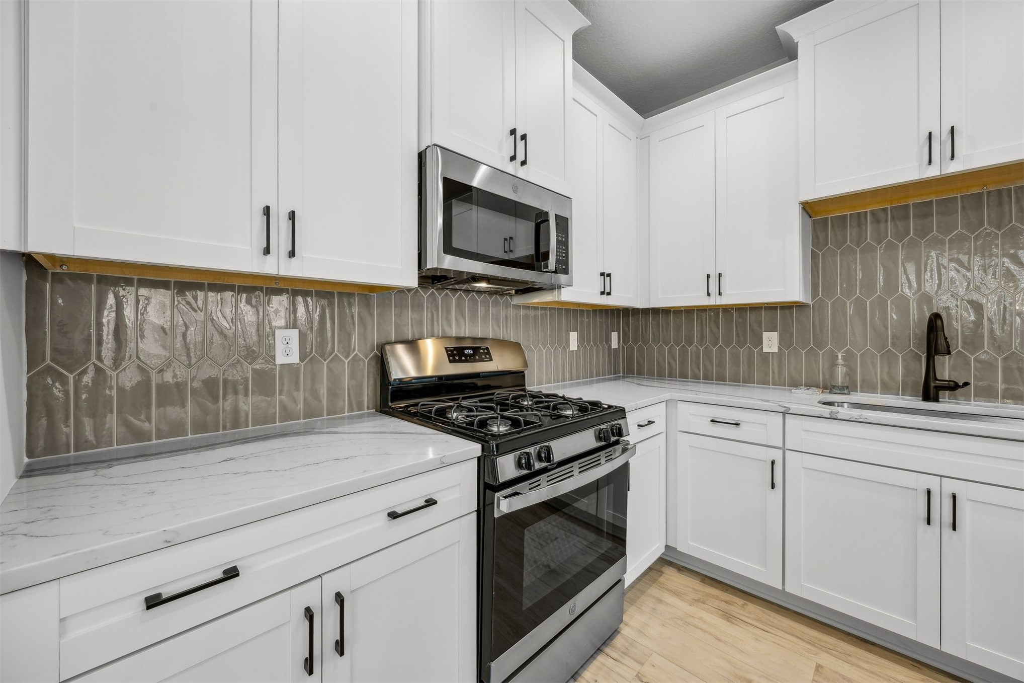 230 Wildlight Avenue Yulee, FL 32097 - Photo 10 of 73 a kitchen with stainless steel appliances granite countertop white cabinets and a stove