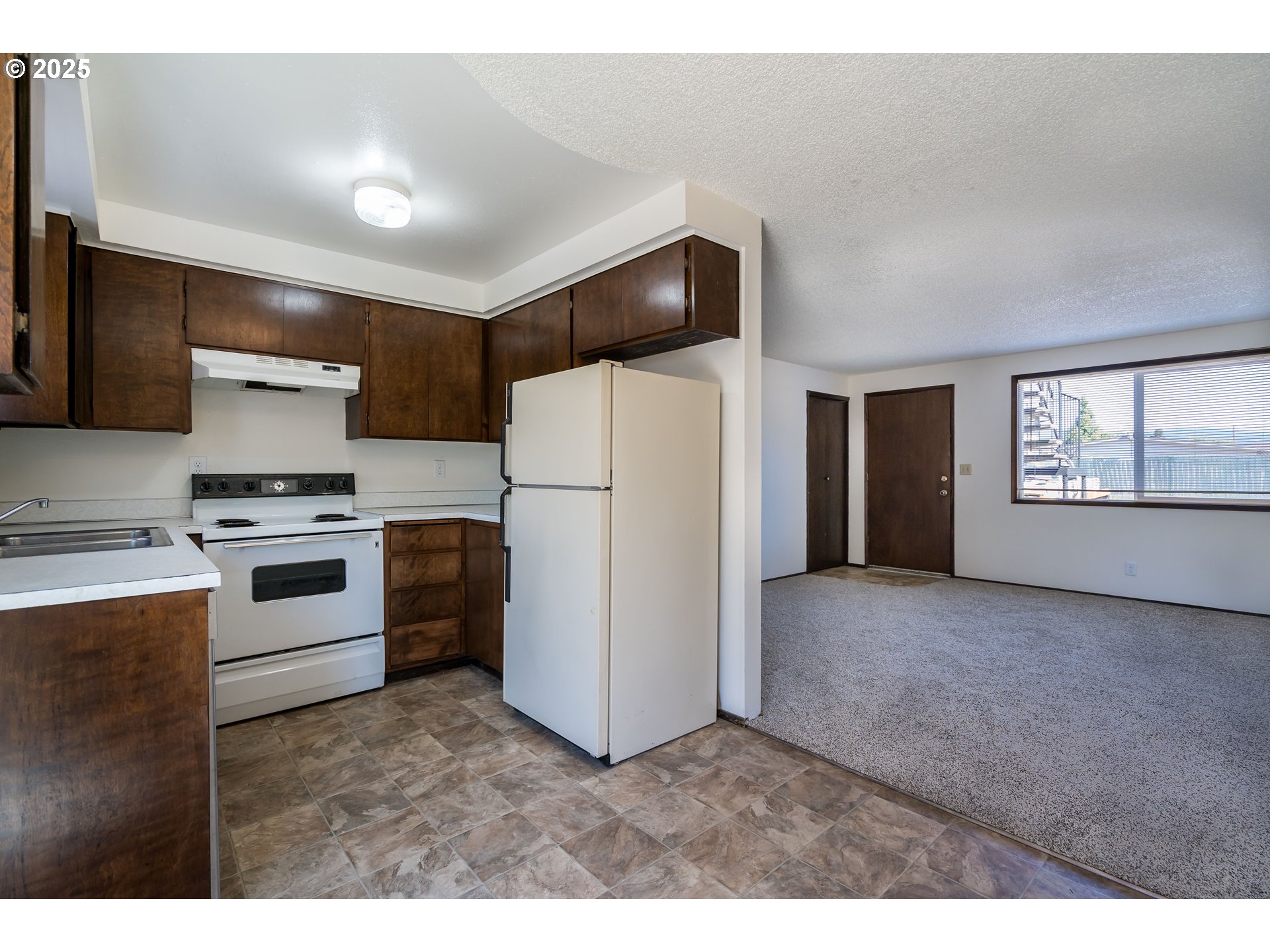 231 South 40th Street Springfield, OR 97478 - Photo 6 of 19 a kitchen with white cabinets and white appliances