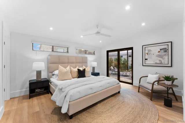 a bedroom with a large bed couch and a window