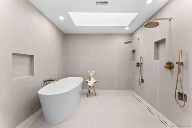 a white bath tub sitting next to a white toilet