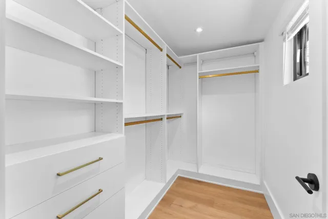 a view of walk in closet with empty racks