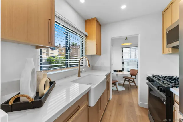 a kitchen with granite countertop a sink and a stove top oven