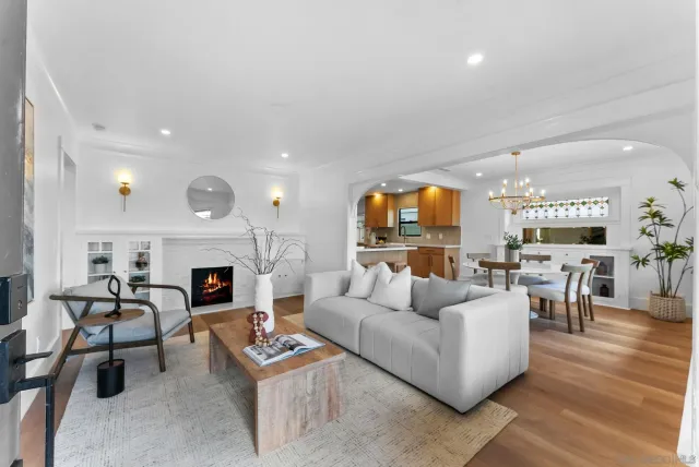 a living room with furniture fireplace and a table