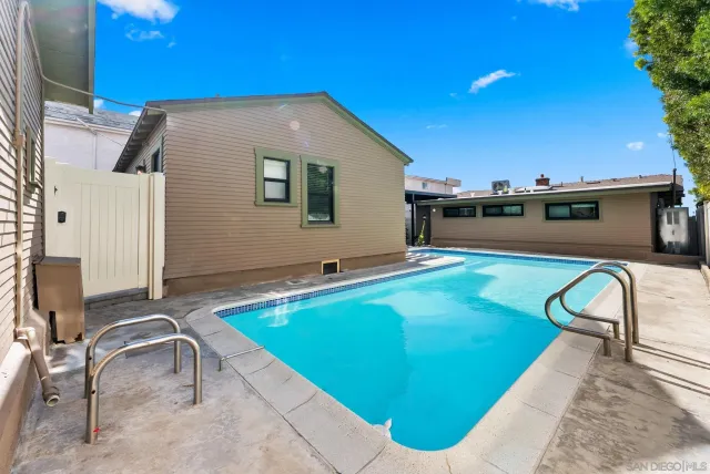 a swimming pool with outdoor seating and yard