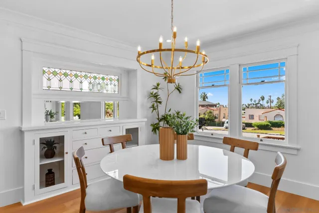 a view of a dining room with furniture a chandelier and wooden floor