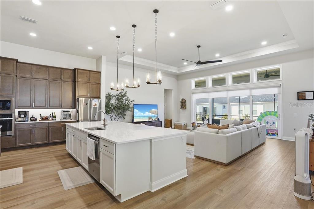 12030 Southwest 32nd Lane Gainesville, FL 32608 - Photo 14 of 57 a large kitchen with kitchen island a large island in it