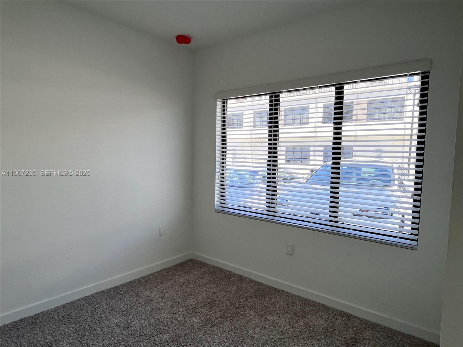 14559 Southwest 261st Street, Unit 14559 Homestead, FL 33032 - Photo 3 of 15 a view of an empty room with a window