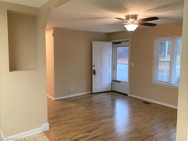 1060 Cb Eller School Road Elkin, NC 28621 - Photo 3 of 17 Living Room with new flooring and nice natural light and ceiling fan