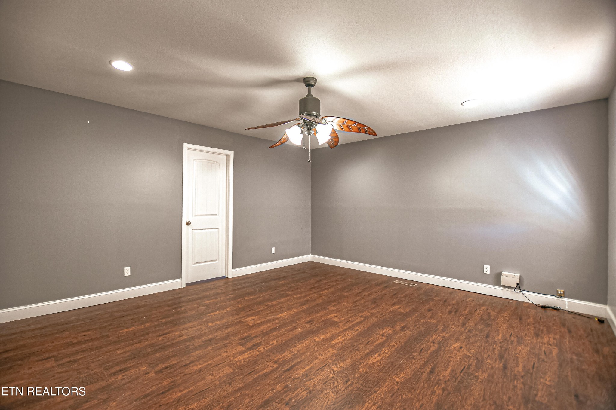 4091 Pleasant Grove Road Winfield, TN 37892 - Photo 17 of 28 an empty room with wooden floor and chandelier fan