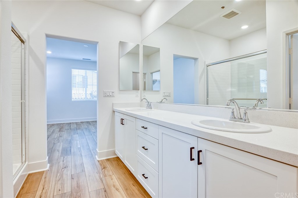 5603 Kate Way Fontana, CA 92336 - Photo 13 of 63 a spacious bathroom with double sink and a mirror