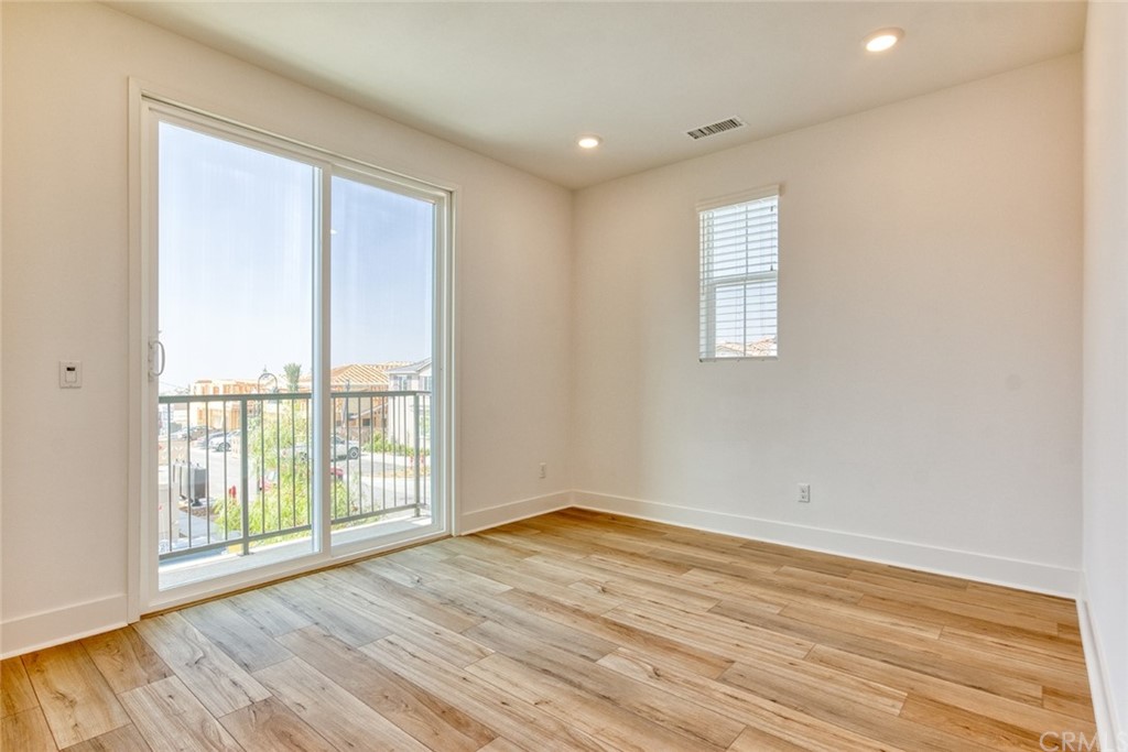5603 Kate Way Fontana, CA 92336 - Photo 20 of 63 an empty room with wooden floor and windows