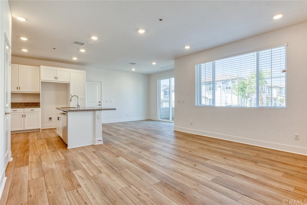 5603 Kate Way Fontana, CA 92336 - Photo 24 of 63 a view of kitchen with granite countertop cabinets and wooden floor