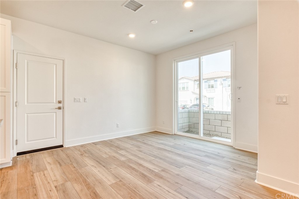 5603 Kate Way Fontana, CA 92336 - Photo 34 of 63 an empty room with wooden floor and windows