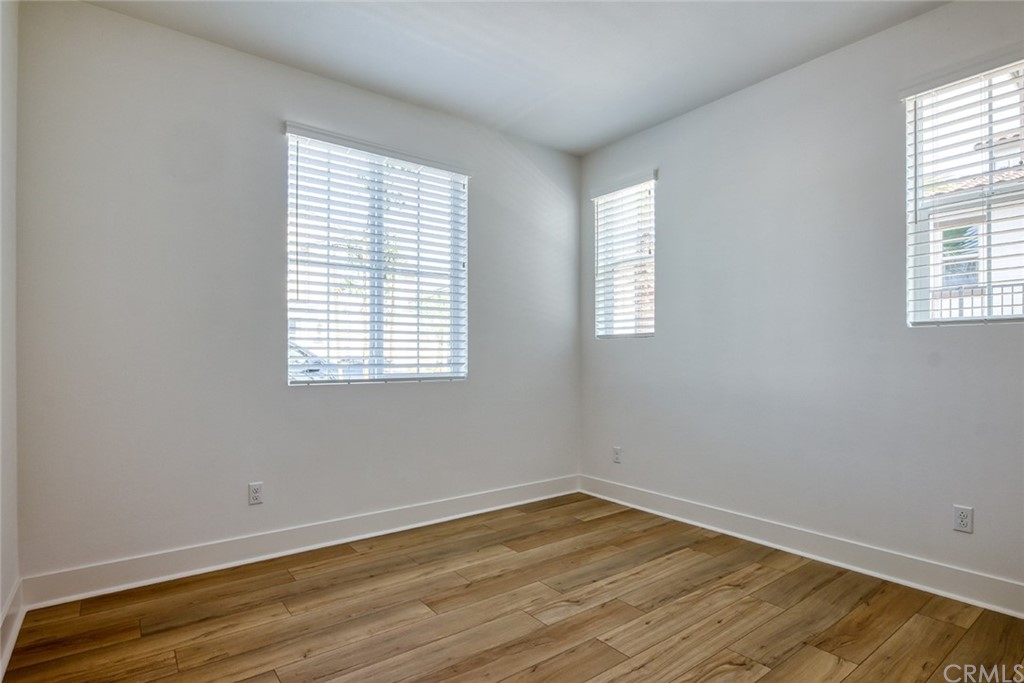 5603 Kate Way Fontana, CA 92336 - Photo 7 of 63 an empty room with wooden floor and windows