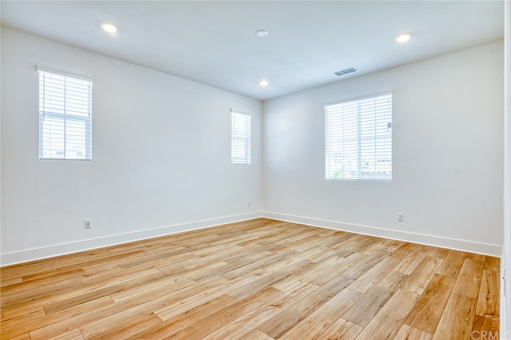 5603 Kate Way Fontana, CA 92336 - Photo 10 of 63 an empty room with wooden floor and windows