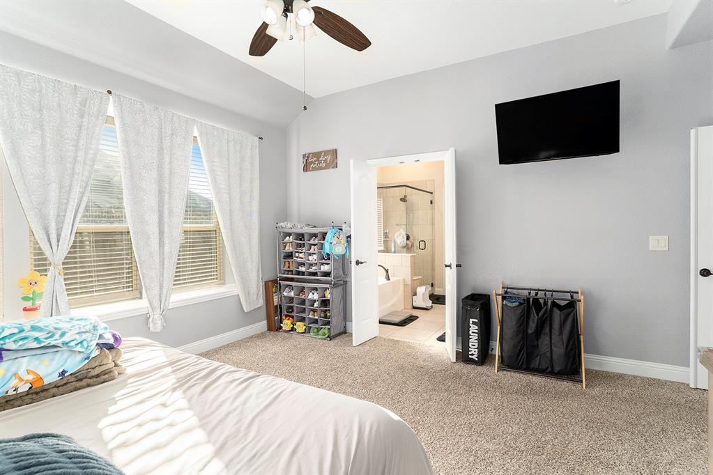 1076 Imperial Eagle Road Alvarado, TX 76009 - Photo 15 of 32 a bedroom with a bed a television and a window
