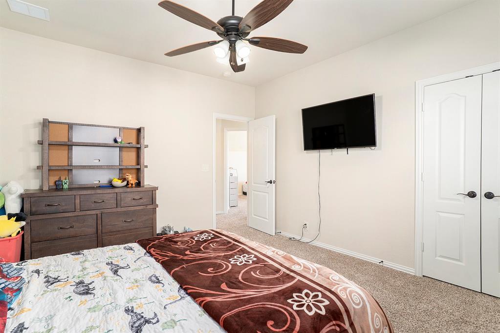 1076 Imperial Eagle Road Alvarado, TX 76009 - Photo 27 of 32 a bedroom with a bed and a flat screen tv