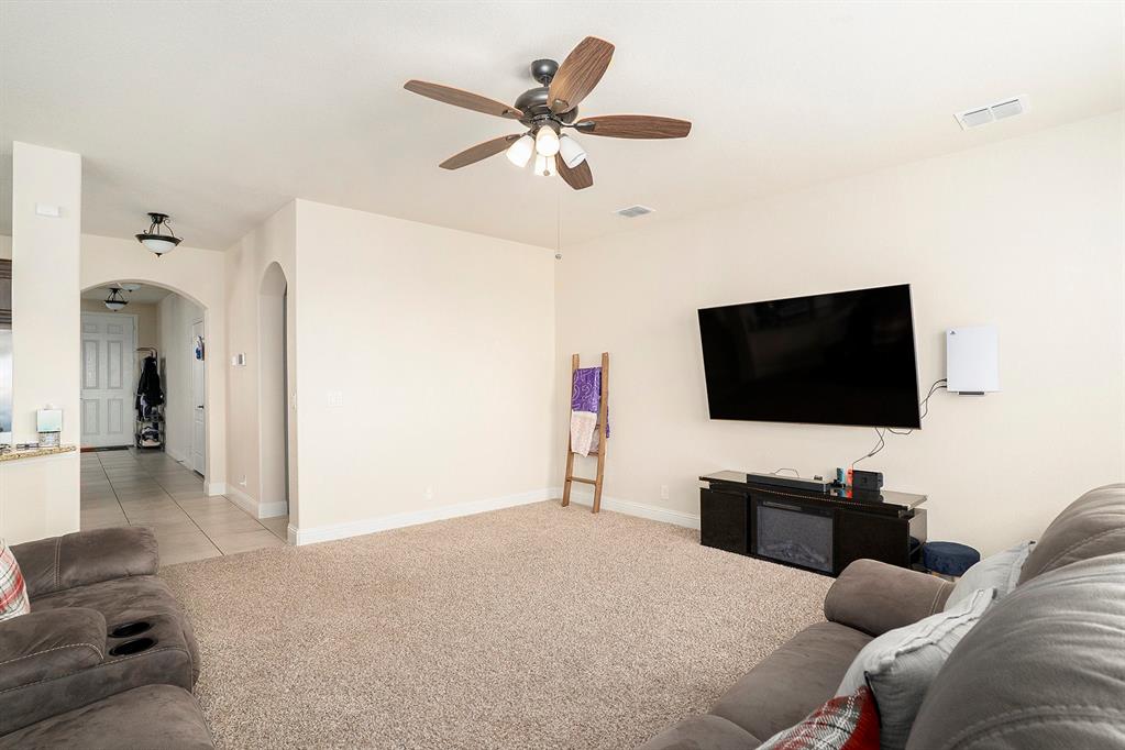 1076 Imperial Eagle Road Alvarado, TX 76009 - Photo 5 of 32 a bedroom with a bed and a flat screen tv