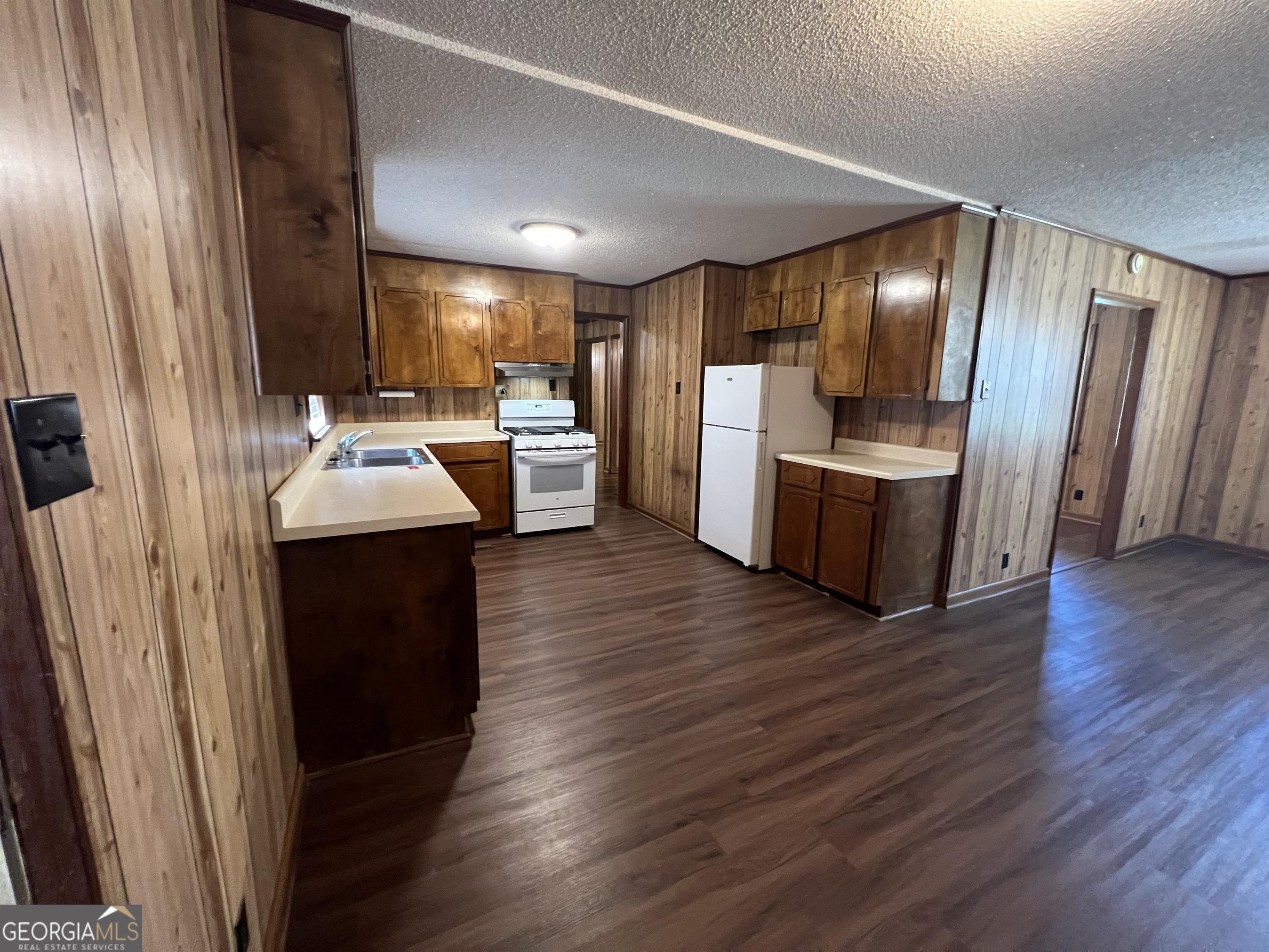 404 McArthur Boulevard Warner Robins, GA 31093 - Photo 5 of 10 a kitchen with sink a refrigerator and wooden floor