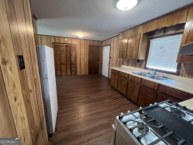 a kitchen with stainless steel appliances a refrigerator and a stove